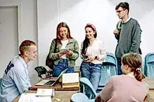 A diverse group of college students engaging in a lively study session indoors.